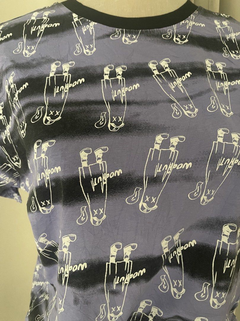 Purple Graphic Print Ringertee (Category: Shirts) located in Cainta. Submitted by zlove111 (Listing ID 1470738506, Image 3). Description: - Style: Streetwear casual short sleeve t-shirt - Design: Purple base with black horizontal stripes and all-over white cartoon character print - Details: Black contrast ringer crewneck collar - Material: Soft, comfortable cotton - Fit: Standard casual fit small/semi large - Versatility: Easy to style with denim