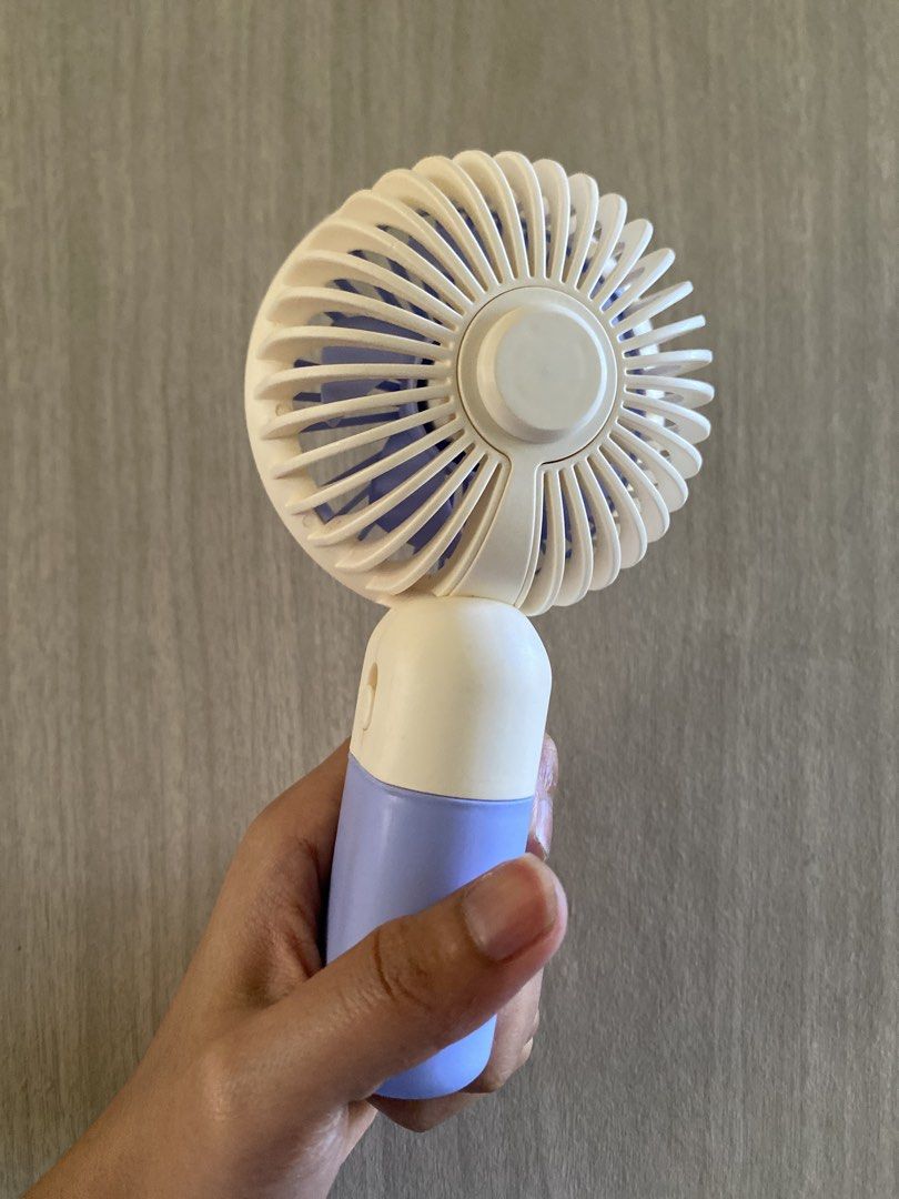 Purple Portable Handheld Mini Fan Rechargeable (Category: Fans) located in Cainta. Submitted by stuff_4_sale_dump (Listing ID 1470627747, Image 3). Description: compact and lightweight built-in stand fan + phone holder slot with USB charging cable comes in its original box.