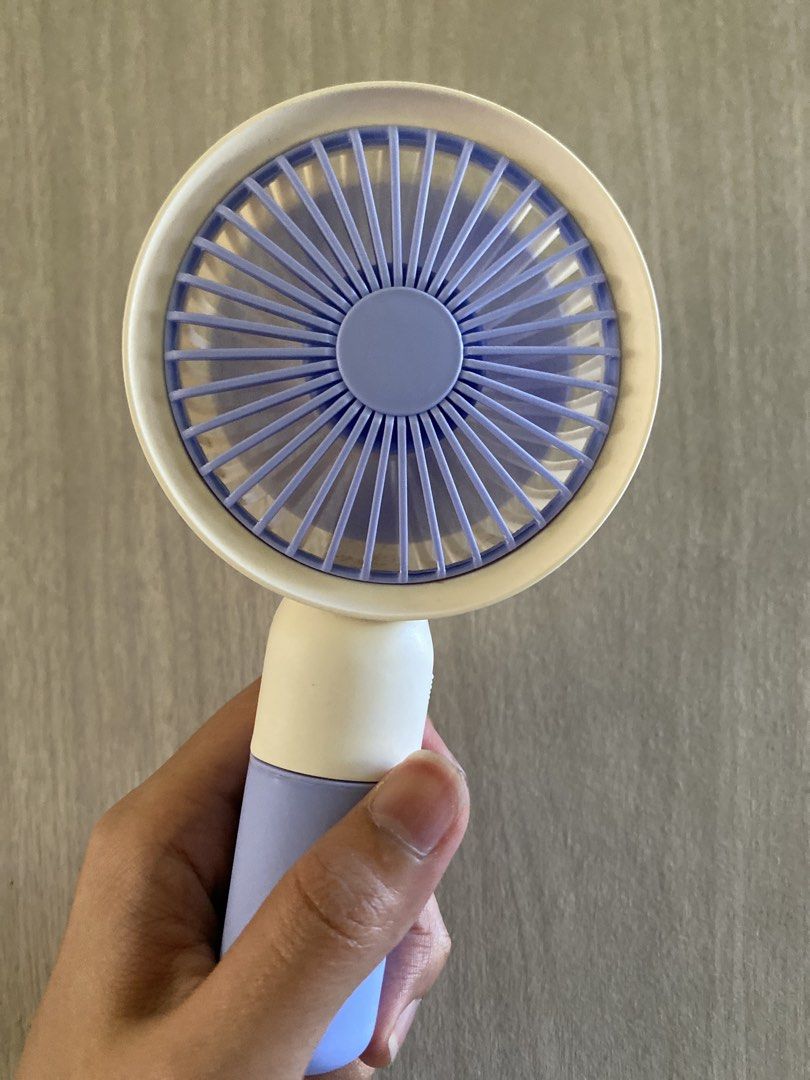 Purple Portable Handheld Mini Fan Rechargeable (Category: Fans) located in Cainta. Submitted by stuff_4_sale_dump (Listing ID 1470627747, Image 2). Description: compact and lightweight built-in stand fan + phone holder slot with USB charging cable comes in its original box.