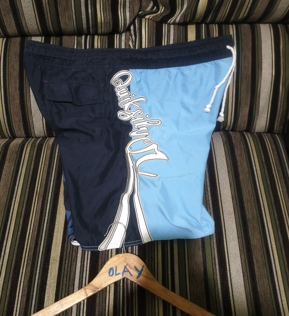 Quiksilver Blue Board Shorts Swim Trunks (Category: Swim Trunks & Board Shorts) located in Taguig. Submitted by conniemdcruz (Listing ID 1470699219, Image 3). Description: - Authentic Quiksilver board shorts - Stylish light blue and dark blue colorway with block panel design - Large brand logo text printed vertically on the side - Adjustable white drawstring waist with matching eyelets - Convenient back pocket with flap closure - Ideal for swimmi