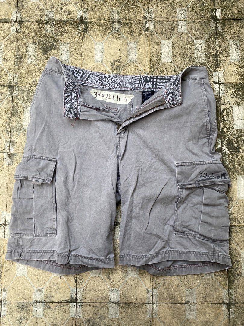 Quiksilver Gray Cargo Shorts Size 34 (Category: Shorts) located in Imus. Submitted by frootiloots4103 (Listing ID 1470717557, Image 1). Description: - Brand: Quiksilver - Color: Gray - Size: 34 - Material: Rugged cotton with a washed finish - Features: Multiple side pockets, signature script branding on the pocket flap - Details: Patterned inner waistband lining with red contrast stitching - Condition: Good staple piece for everyday wear OPEN FOR