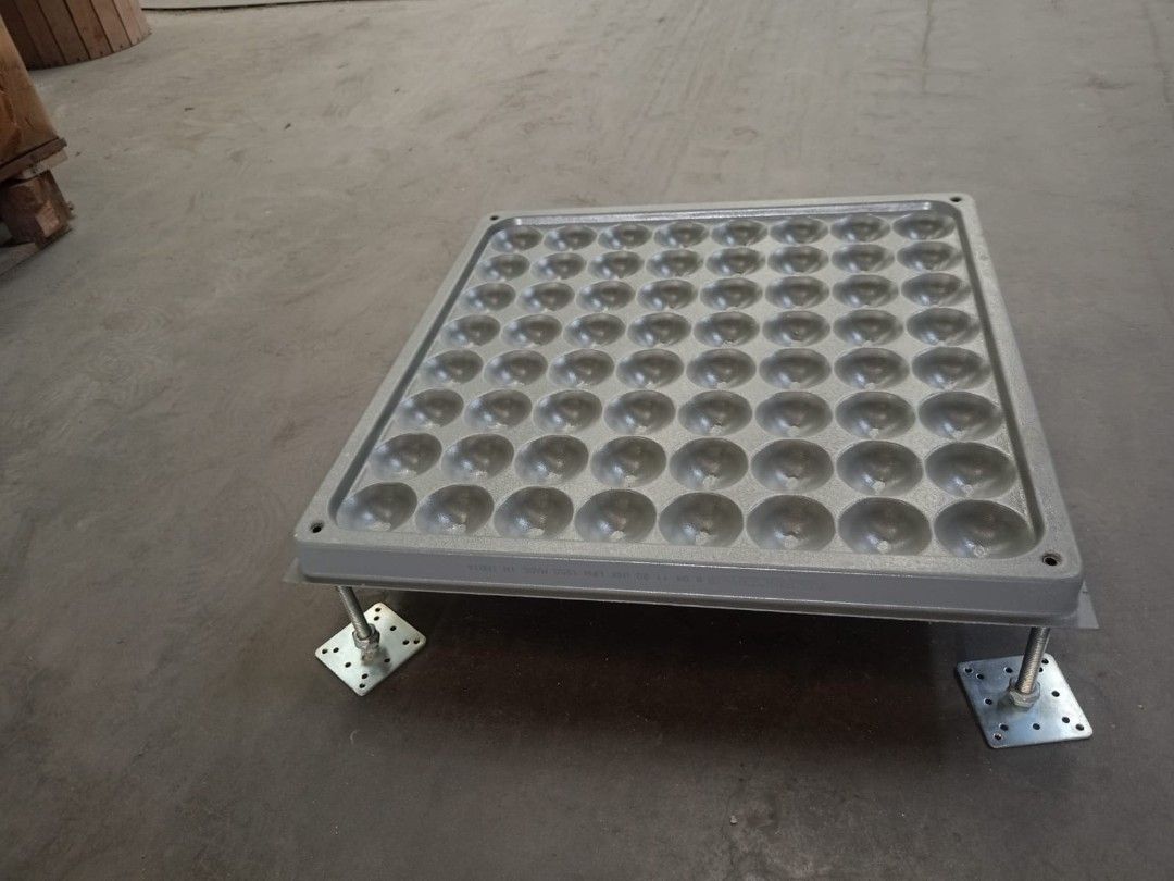 Raised access floor tile with adjustable metal pedestal stands (Category: Construction & Building Materials) located in Makati City. Submitted by mandiajan62104 (Listing ID 1470595317, Image 3). Description: - Material: Heavy-duty metal in grey - Design: Dimpled underside for enhanced structural strength - Inclusions: Four adjustable threaded pedestals with square base plates - Application: Standard raised flooring for server rooms and office bui