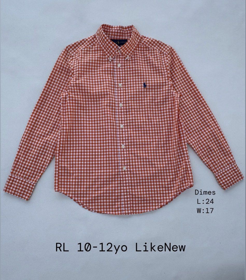 Ralph Lauren Orange Gingham Button Down Shirt (Category: Babies & Kids Fashion) located in Pozorrubio. Submitted by izaykite2g (Listing ID 1470683946, Image 1). Description: - Brand: Ralph Lauren - Design: Orange and white gingham check pattern with navy embroidered pony logo - Style: Long sleeves, button-down collar, and front button closure - Size: Fits boys aged 10 to 12 years - Measurements: Length 24 inches, Width 17 inches - Condition: Exce