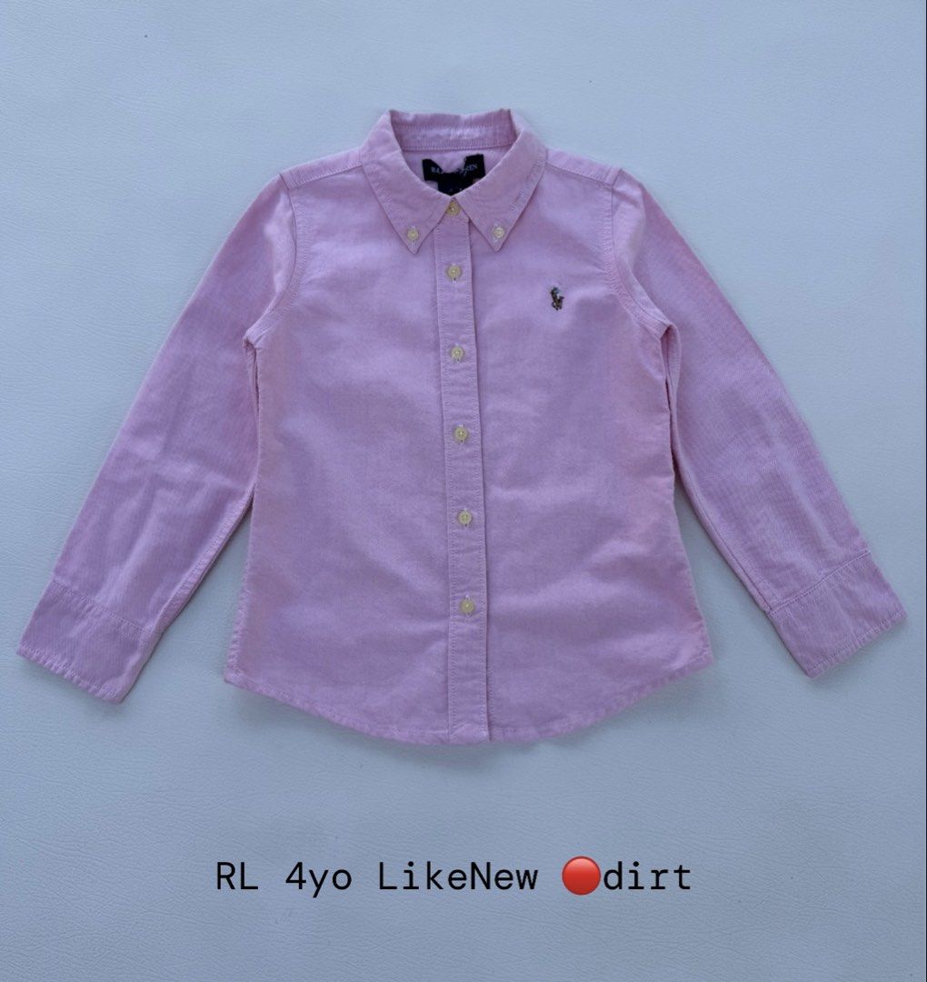 Ralph Lauren Pink Button-Down Shirt Kids Size (Category: Babies & Kids Fashion) located in Pozorrubio. Submitted by izaykite2g (Listing ID 1470683682, Image 1). Description: - Brand: Ralph Lauren - Color: Light pink - Material: Soft corduroy fabric - Size: Fits around 4 years old - Features: Long sleeves, classic collar, front button closure, signature embroidered pony logo - Condition: Clean, smoke-free home, ready to wear.