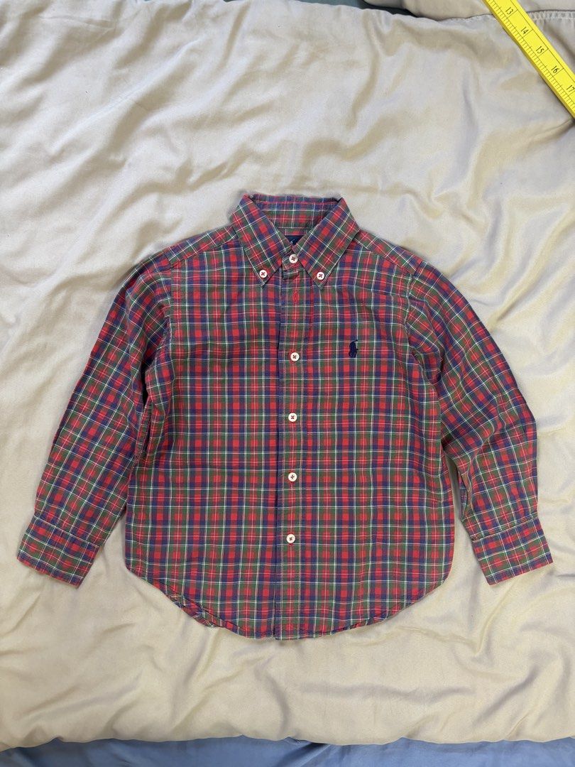 Ralph Lauren Plaid Button-Down Shirt Size 4/4T (Category: Babies & Kids Fashion) located in Ajuy. Submitted by galitsabarat (Listing ID 1470614551, Image 1). Description: - Brand: Ralph Lauren - Item: Long sleeve button-down shirt - Size: 4/4T - Pattern: Classic red, green, and blue plaid - Details: Signature embroidered pony logo on chest, button-down collar, white buttons - Measurements: Pit to pit ~13-14 inches, Length ~18 inches - Condition: 