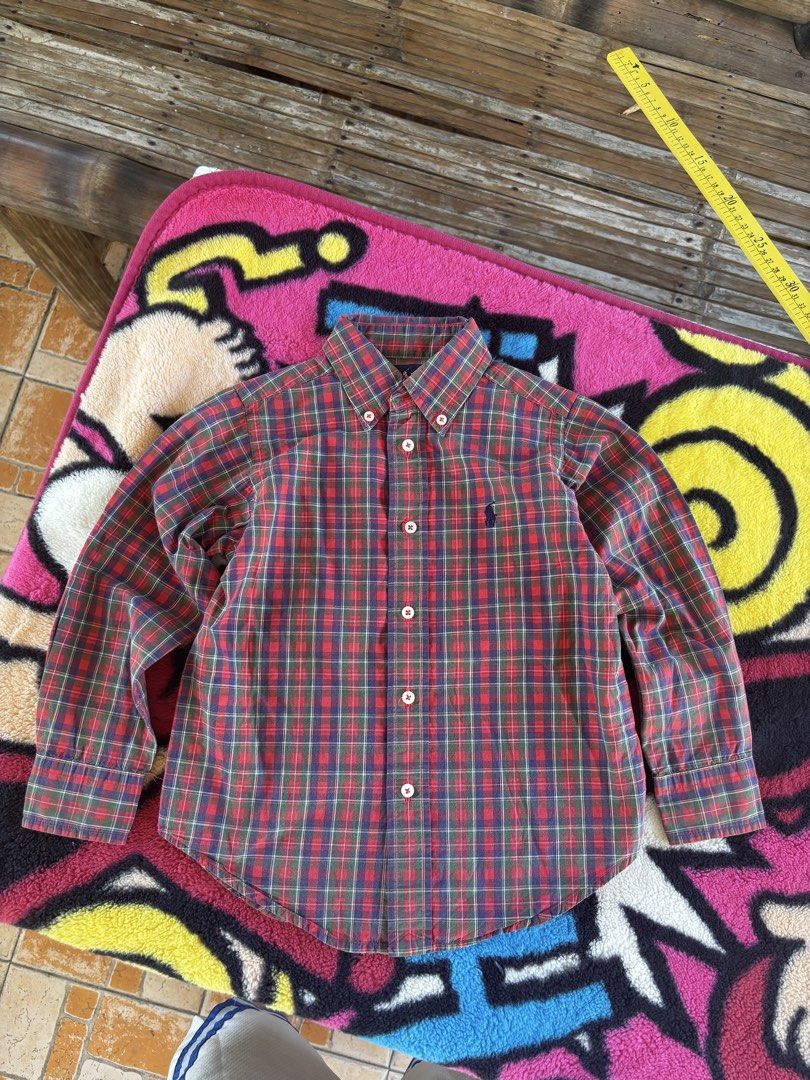 Ralph Lauren Plaid Button-Down Shirt Size 4/4T (Category: Babies & Kids Fashion) located in Ajuy. Submitted by galitsabarat (Listing ID 1470614551, Image 3). Description: - Brand: Ralph Lauren - Item: Long sleeve button-down shirt - Size: 4/4T - Pattern: Classic red, green, and blue plaid - Details: Signature embroidered pony logo on chest, button-down collar, white buttons - Measurements: Pit to pit ~13-14 inches, Length ~18 inches - Condition: 