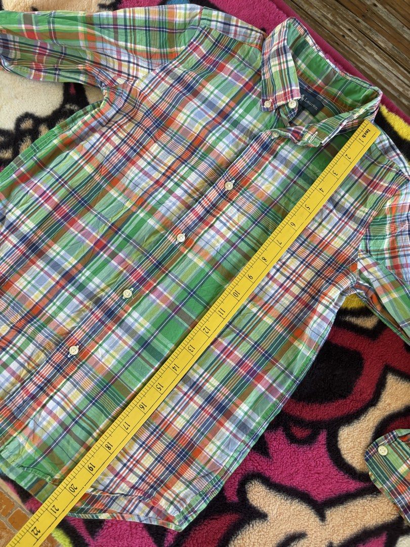 Ralph Lauren Plaid Button-Down Shirt Size 7 (Category: Babies & Kids Fashion) located in Ajuy. Submitted by galitsabarat (Listing ID 1470615137, Image 3). Description: - Brand: Ralph Lauren - Item: Boys button-down shirt - Design: Green plaid with blue, orange, and white accents - Size: 7 (130/64) - Details: Classic collar, long sleeves, front button closure, signature embroidered pony logo - Condition: Clean, excellent, and ready to wear.