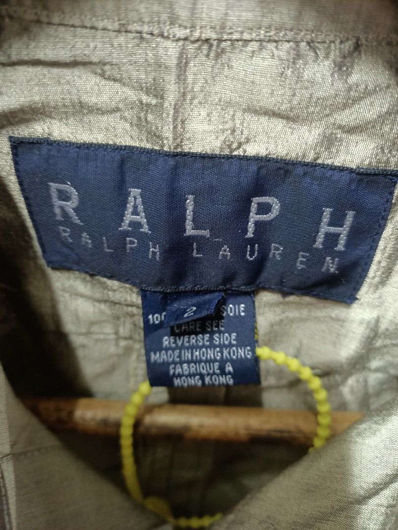 Ralph Lauren Silk Dress Button Down (Category: Longsleeves) located in Bayombong. Submitted by rheaaa00530 (Listing ID 1470664895, Image 2). Description: - Brand: Ralph Lauren - Style: Long sleeve button-down Dress with classic collar and single button cuffs - Color/Finish: Shimmering greyish-gold metallic hue - Material: 100% Raw Silk (Soie), lightweight with natural textured wrinkling - Size: 2 (Tagged) - Origin: Crafted in Hong Kong - Conditio