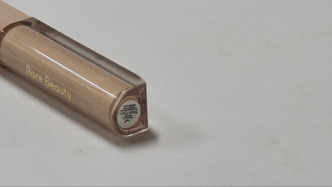 Rare Beauty Positive Light Under Eye Brightener (Category: Makeup) located in Manila. Submitted by fcloset24 (Listing ID 1470580713, Image 3). Description: - Brand: Rare Beauty - Product: Positive Light Under Eye Brightener - Shade: Light/Medium - Size: 0.13 fl oz / 4.0 mL - Condition: Swatched once on hand, practically full tube - Reason for selling: Shade mismatch - Features: Creamy liquid formula with an easy applicator wand for instant bright