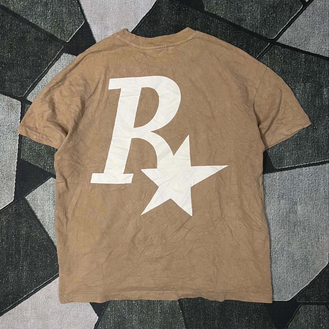 Rass Logo Brown T-Shirt Oversized (Category: Tshirts & Polo Shirts ) located in Cebu City. Submitted by royalwolf-2a85 (Listing ID 1470693769, Image 2). Description: - Brown oversized graphic tee with vintage wash - Iconic Rockstar Games logo on front and back - Soft and comfortable cotton fabric - Crew neckline and short sleeves - Minimal wear with clean, crack-free graphics - like New - no issue .