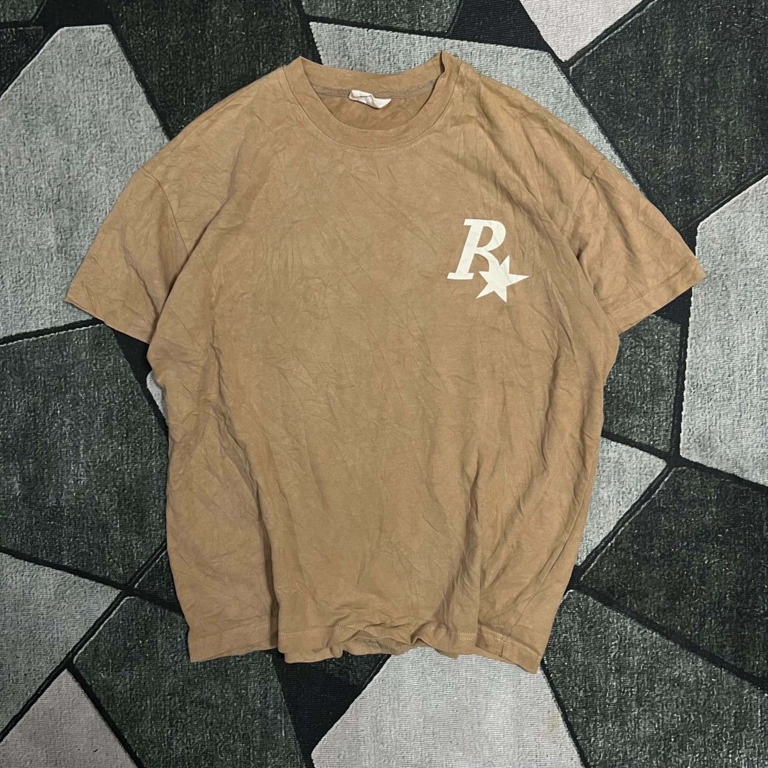 Rass Logo Brown T-Shirt Oversized (Category: Tshirts & Polo Shirts ) located in Cebu City. Submitted by royalwolf-2a85 (Listing ID 1470693769, Image 1). Description: - Brown oversized graphic tee with vintage wash - Iconic Rockstar Games logo on front and back - Soft and comfortable cotton fabric - Crew neckline and short sleeves - Minimal wear with clean, crack-free graphics - like New - no issue .