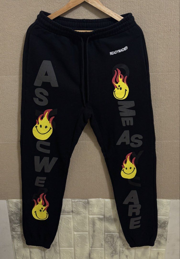 READYMADE Fire Smile Print Sweatpants (Category: Joggers) located in San Fernando. Submitted by jyyyshytt (Listing ID 1470688571, Image 1). Description: Excellent condition No issue Color rate:9.5/10 Dimensions:W30-34 L42 hem 6.