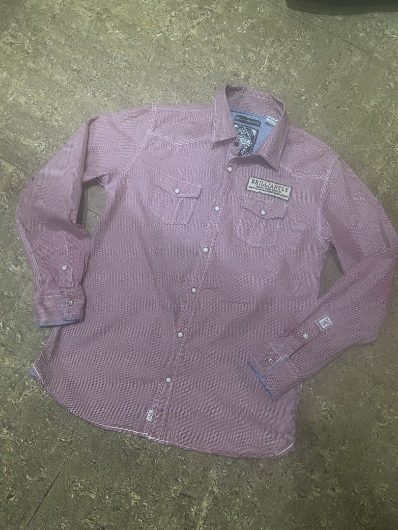Real Crush Red Checkered Button-Up Shirt Size M (Category: Shirts) located in Binan City. Submitted by maggierabi01434 (Listing ID 1470736439, Image 2). Description: - Brand/Model: Real Crush - Size: Medium (M) - Color/Pattern: Red checkered with blue contrast fabric inside collar and cuffs - Closure: Snap-down front and snap-button chest pockets - Details: Eye-catching graphic print on the back - Origin: Made in China - Condition: Great casual w