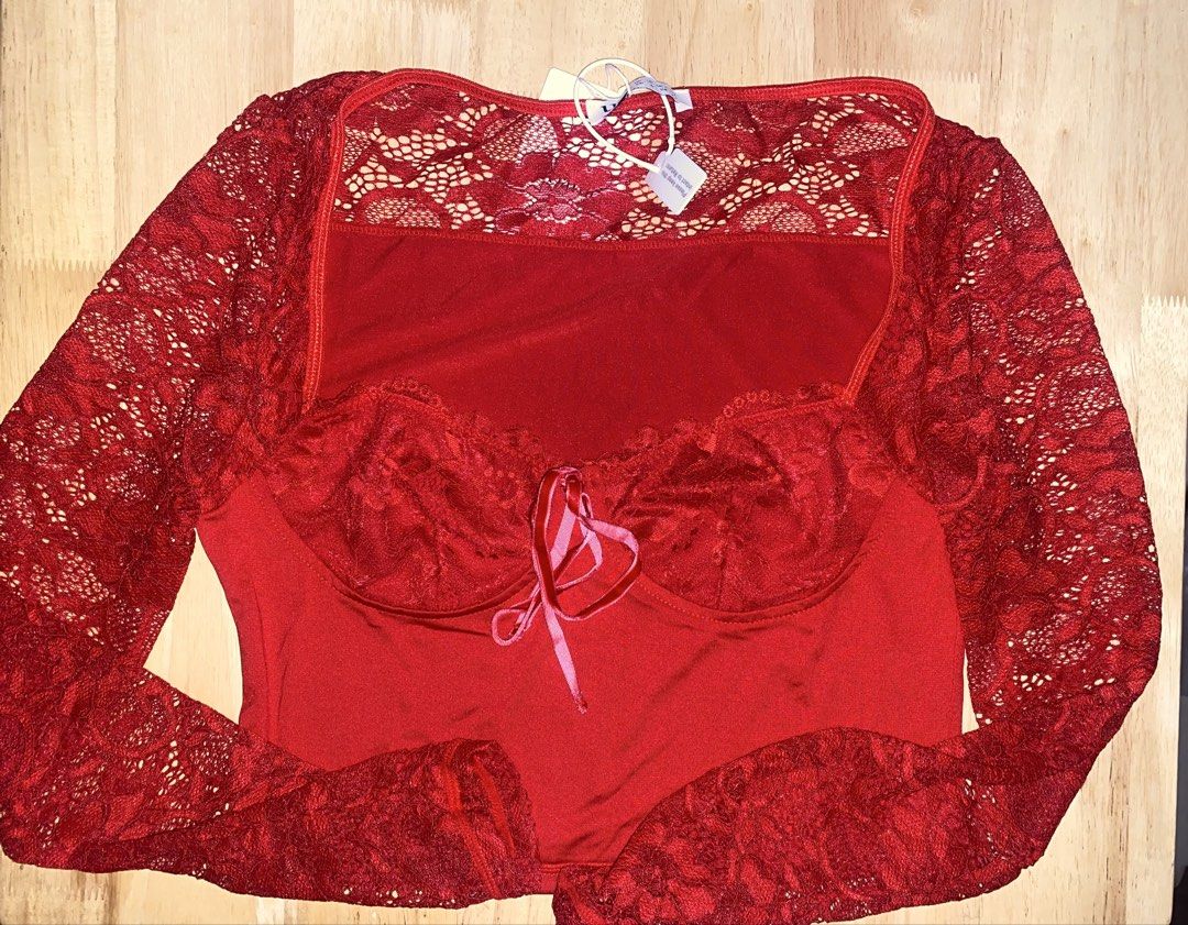 Red lace crop top (Category: Blouses) located in Cavite. Submitted by helloize (Listing ID 1470640717, Image 3). Description: - Brand: Urbanic - Condition: Brand new with original retail tags attached - Size: XS (EU 34 / UK 6 / US 2) - Color: Vibrant red with contrasting light pink ribbon tie - Design: Delicate lace sleeves and upper panel with fitted silhouette - Features: Built-in molded cups for extra support and shape Best fit Small Good qual