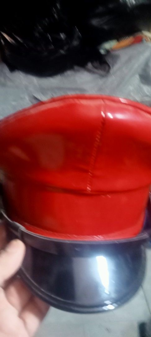 Red patent leather uniform hat with black visor (Category: Caps & Hats) located in Paranaque City. Submitted by dimaguilaa24827 (Listing ID 1470646552, Image 1). Description: - Color: Bright red with shiny patent leather finish - Design: Black visor, matching band, and structured crown - Details: Clean construction with visible top-stitching - Perfect for: Costumes, parties, and bold fashion wear.