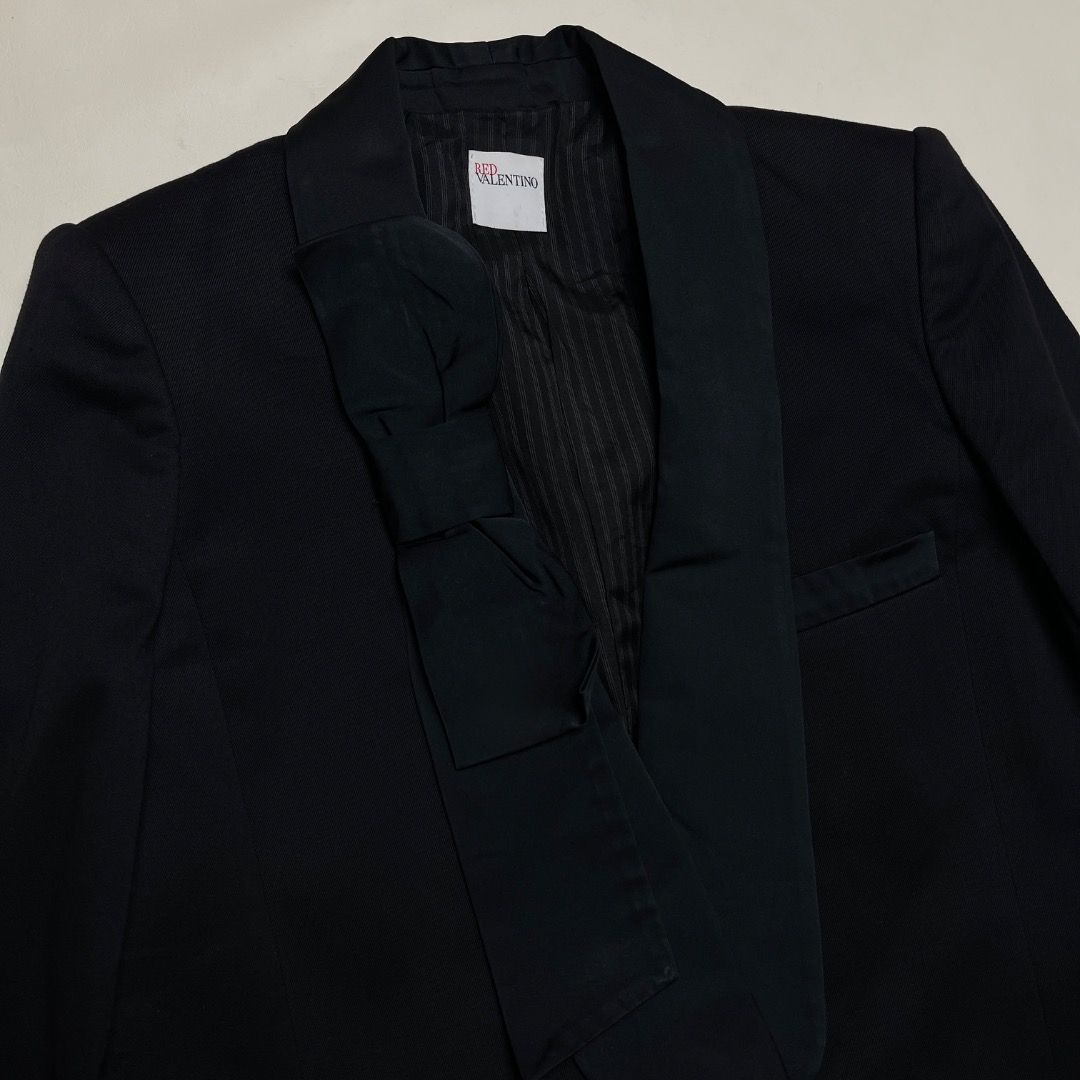 Red Valentino Black Bowtie Blazer (Category: Coats, Jackets and Outerwear) located in Caloocan City. Submitted by achilles_grails (Listing ID 1470675027, Image 2). Description: - Brand: Red Valentino - Color: Classic Black - Origin: Made in Italy - Material: 58% Cotton, 41% Virgin Wool, 1% Spandex (High-quality premium blend) - Features: Unique lapel bowtie design, chic striped inner lining, tailored fit - Condition: Excellent pre-loved condition