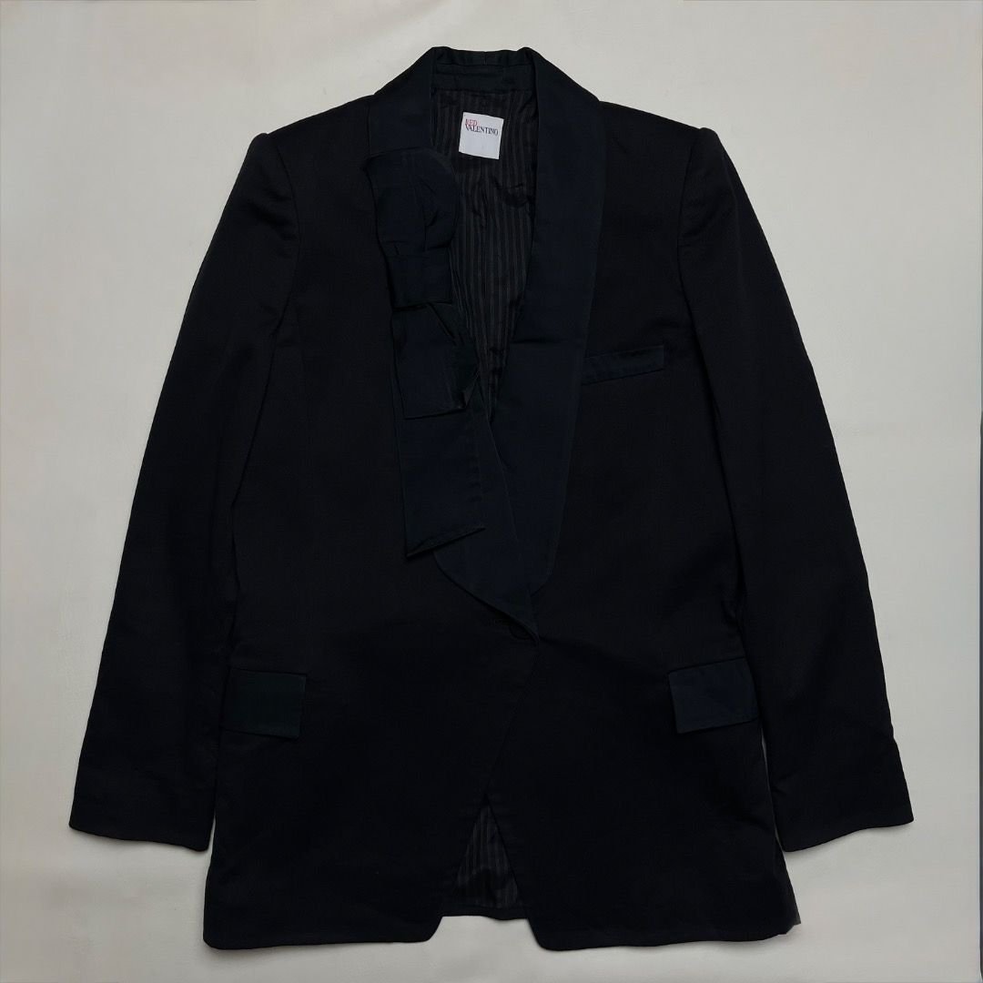 Red Valentino Black Bowtie Blazer (Category: Coats, Jackets and Outerwear) located in Caloocan City. Submitted by achilles_grails (Listing ID 1470675027, Image 1). Description: - Brand: Red Valentino - Color: Classic Black - Origin: Made in Italy - Material: 58% Cotton, 41% Virgin Wool, 1% Spandex (High-quality premium blend) - Features: Unique lapel bowtie design, chic striped inner lining, tailored fit - Condition: Excellent pre-loved condition