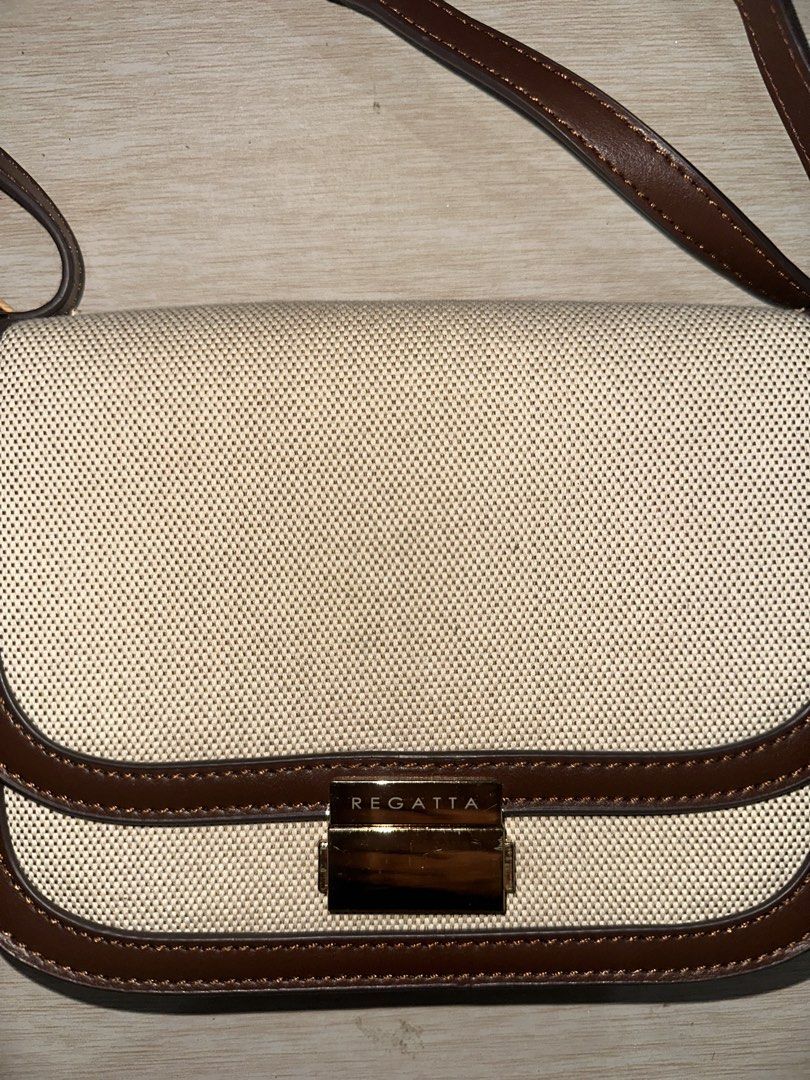 Regatta Crossbody Bag Beige Brown (Category: Cross-body Bags) located in Manila. Submitted by zayzay08 (Listing ID 1470727863, Image 1). Description: - Brand: Regatta - Color: Neutral beige canvas with brown leather-look trim - Closure: Flap with secure gold-tone metal lock hardware - Strap: Adjustable brown strap for a custom fit - Interior: Fabric-lined with a convenient zippered pocket - Style: Versatile and chic, perfect for pairing with ever