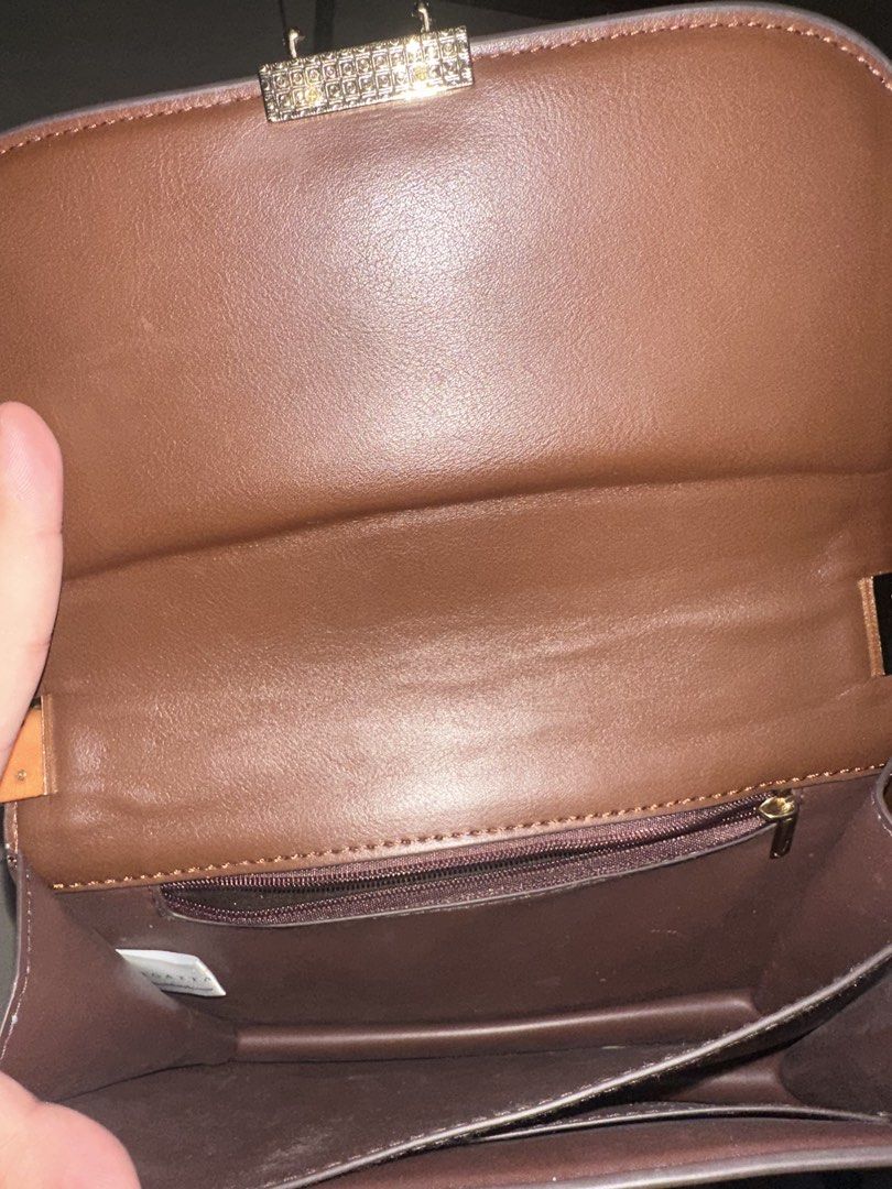 Regatta Crossbody Bag Beige Brown (Category: Cross-body Bags) located in Manila. Submitted by zayzay08 (Listing ID 1470727863, Image 3). Description: - Brand: Regatta - Color: Neutral beige canvas with brown leather-look trim - Closure: Flap with secure gold-tone metal lock hardware - Strap: Adjustable brown strap for a custom fit - Interior: Fabric-lined with a convenient zippered pocket - Style: Versatile and chic, perfect for pairing with ever