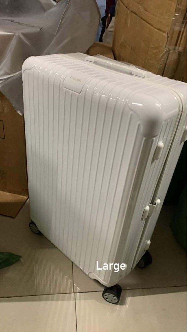 Rimowa Large Suitcase (Category: Luggage) located in Caloocan City. Submitted by melissajto31605 (Listing ID 1470683315, Image 1). Description: - Brand: Rimowa Large Suitcase - Colors available: White, Blue, Orange, and Purple - Exterior: Durable hard shell with iconic grooved design for ultimate protection - Mobility: Sturdy multi-wheel setup for smooth gliding - Interior: Spacious capacity designed for long trips and heavy packing - Features: S