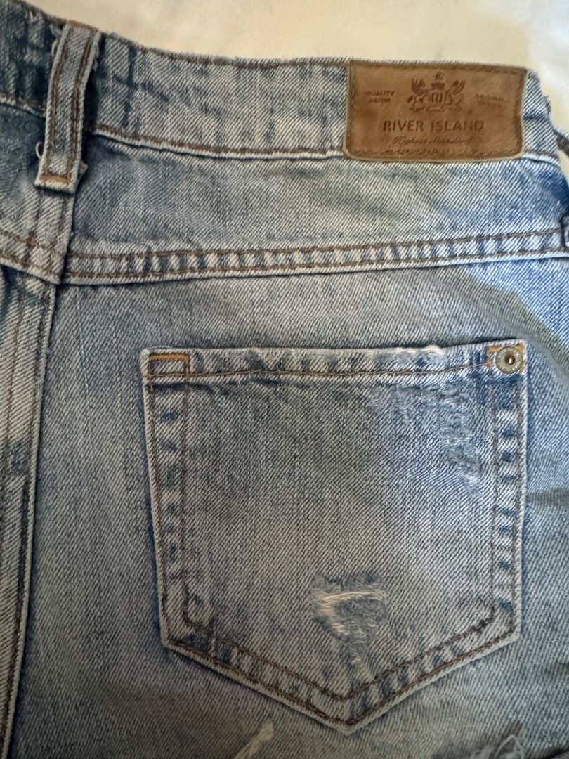 River Island Distressed Denim Shorts Size 6 (Category: Shorts) located in Cebu City. Submitted by _t.rix (Listing ID 1470573206, Image 3). Description: - Brand: River Island - Size: 6 - Wash: Light wash denim - Style: Heavily distressed with ripped front panels - Hem: Trendy frayed raw hem - Details: Classic 5-pocket design, contrast stitching, metal rivets, and back leather brand patch.