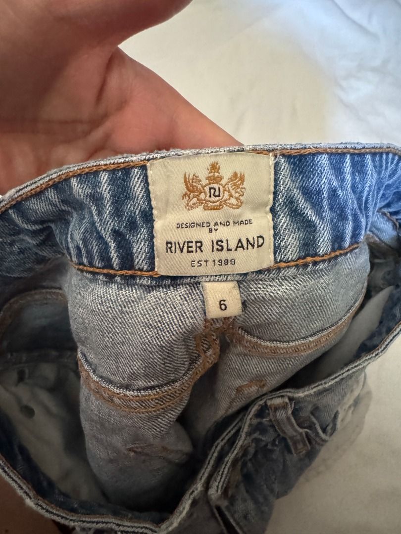River Island Distressed Denim Shorts Size 6 (Category: Shorts) located in Cebu City. Submitted by _t.rix (Listing ID 1470573206, Image 2). Description: - Brand: River Island - Size: 6 - Wash: Light wash denim - Style: Heavily distressed with ripped front panels - Hem: Trendy frayed raw hem - Details: Classic 5-pocket design, contrast stitching, metal rivets, and back leather brand patch.