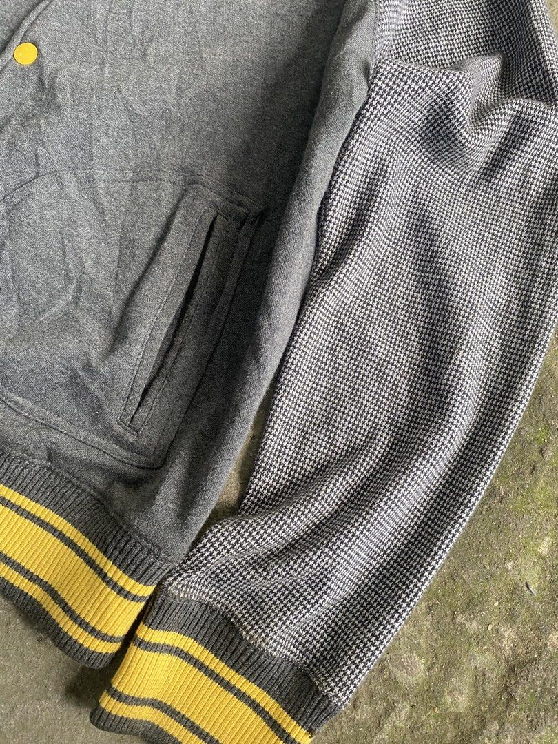 Rocawear Varsity Jacket Grey Houndstooth Sleeves Yellow Ribbing (Category: Coats, Jackets and Outerwear) located in Caloocan City. Submitted by remythrift (Listing ID 1470589868, Image 3). Description: - Brand: Rocawear - Style: Varsity jacket / Streetwear layer - Color: Dark grey with houndstooth patterned sleeves - Details: Yellow and grey striped ribbing (collar, cuffs, hem), front snap button closure, dual side pockets, signature Rocawear tag