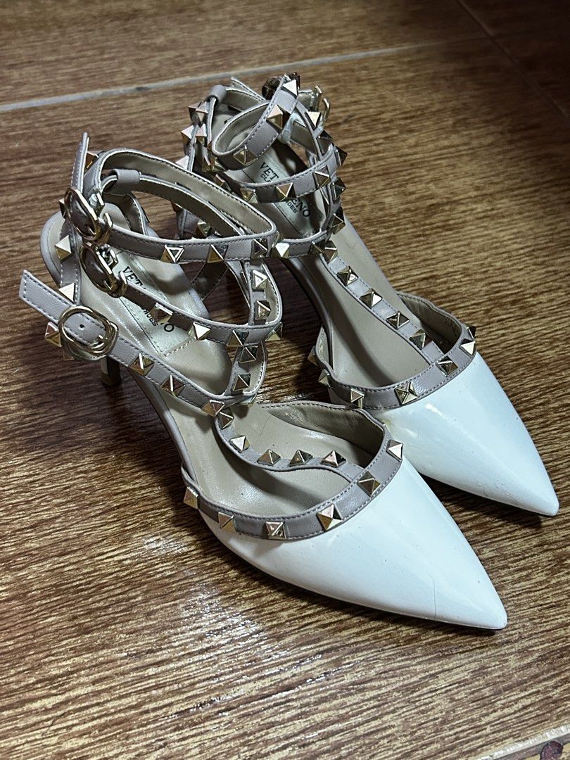Rockstud Pointed Toe T-Strap Heels White Grey (Category: Heels) located in Manila. Submitted by harmsluv (Listing ID 1470643280, Image 1). Description: FOR SALE: Pointed-Toe Studded Strappy Heels 👠✨ DETAILS - Color: White and nude/taupe with gold studs - Style: Pointed-toe, strappy heels - Size: 38-39 - Heel Height: 2.5-3 inches heels - Condition: BRAND NEW/ NEVER BEEN USED 💰 Price: ₱299 negotiable 📍 Location: Fairview, QC 🚚 Delivery: Meetup 