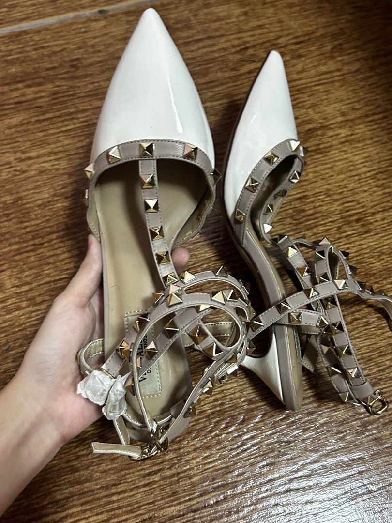 Rockstud Pointed Toe T-Strap Heels White Grey (Category: Heels) located in Manila. Submitted by harmsluv (Listing ID 1470643280, Image 3). Description: FOR SALE: Pointed-Toe Studded Strappy Heels 👠✨ DETAILS - Color: White and nude/taupe with gold studs - Style: Pointed-toe, strappy heels - Size: 38-39 - Heel Height: 2.5-3 inches heels - Condition: BRAND NEW/ NEVER BEEN USED 💰 Price: ₱299 negotiable 📍 Location: Fairview, QC 🚚 Delivery: Meetup 