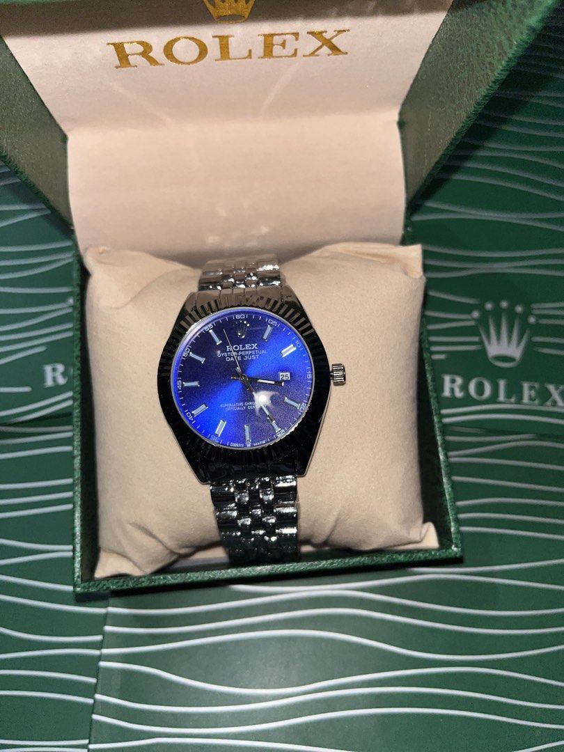 Rolex Oyster Perpetual Datejust Blue Dial Watch (Category: Luxury Watches) located in Manila. Submitted by barditss (Listing ID 1470660676, Image 3). Description: - Authentic Rolex Oyster Perpetual Datejust - Striking blue sunburst dial with silver-tone stainless steel construction - Iconic fluted bezel and comfortable jubilee bracelet - Date window at 3 o'clock with cyclops lens magnifier - Includes official green presentation box with cushion -