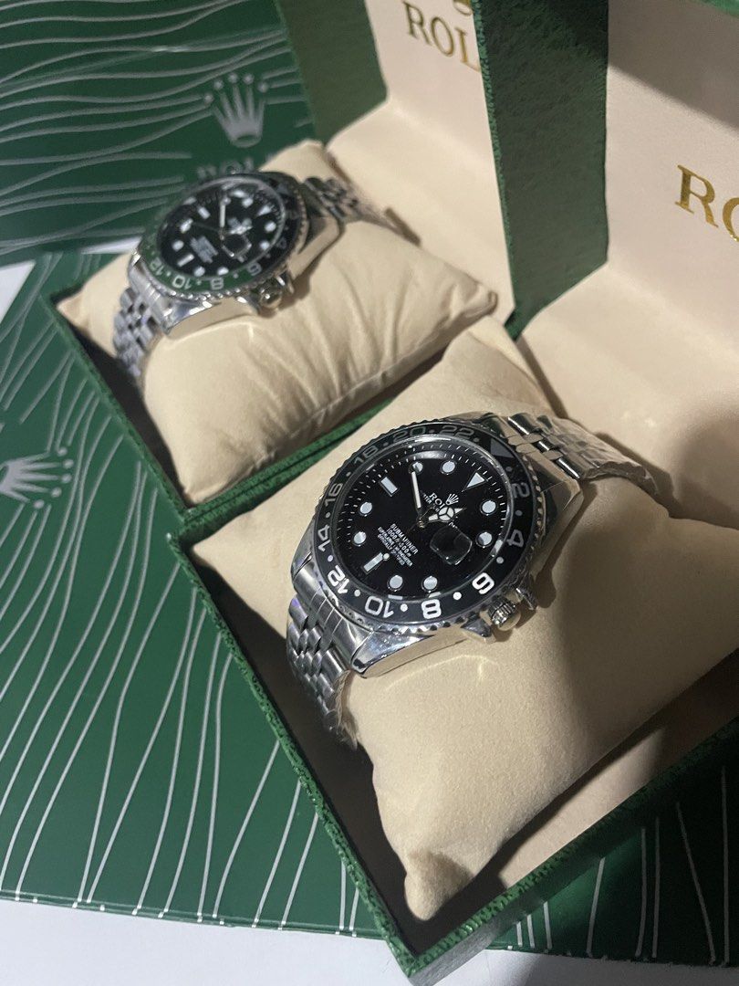 Rolex Submariner GMT Master Watches With Green Boxes (Category: Luxury Watches) located in Manila. Submitted by hype_activity07 (Listing ID 1470722563, Image 1). Description: - Classic Rolex luxury timepieces with stainless steel jubilee bracelets - Features sleek black dials with date windows and cyclops lenses - Includes interchangeable rotating bezels in black and green - Comes complete with two official green presentation boxes and pillow cus
