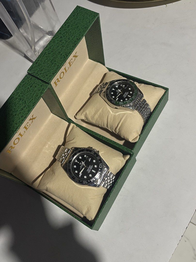 Rolex Submariner GMT Master Watches With Green Boxes (Category: Luxury Watches) located in Manila. Submitted by hype_activity07 (Listing ID 1470722563, Image 3). Description: - Classic Rolex luxury timepieces with stainless steel jubilee bracelets - Features sleek black dials with date windows and cyclops lenses - Includes interchangeable rotating bezels in black and green - Comes complete with two official green presentation boxes and pillow cus