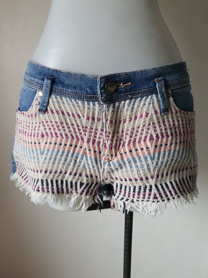 Roxy Denim Boho Woven Front Panel Cutoff Shorts (Category: Shorts) located in Meycauayan. Submitted by shoptoown (Listing ID 1470573839, Image 1). Description: - Brand: Roxy - Size: 7/28 - Style: Denim cutoff shorts with raw fringe hems and classic 5-pocket design - Details: Unique multicolored woven boho pattern panel on the front, button fly - Wash: Blue wash denim - Condition: Great festival-ready piece!.