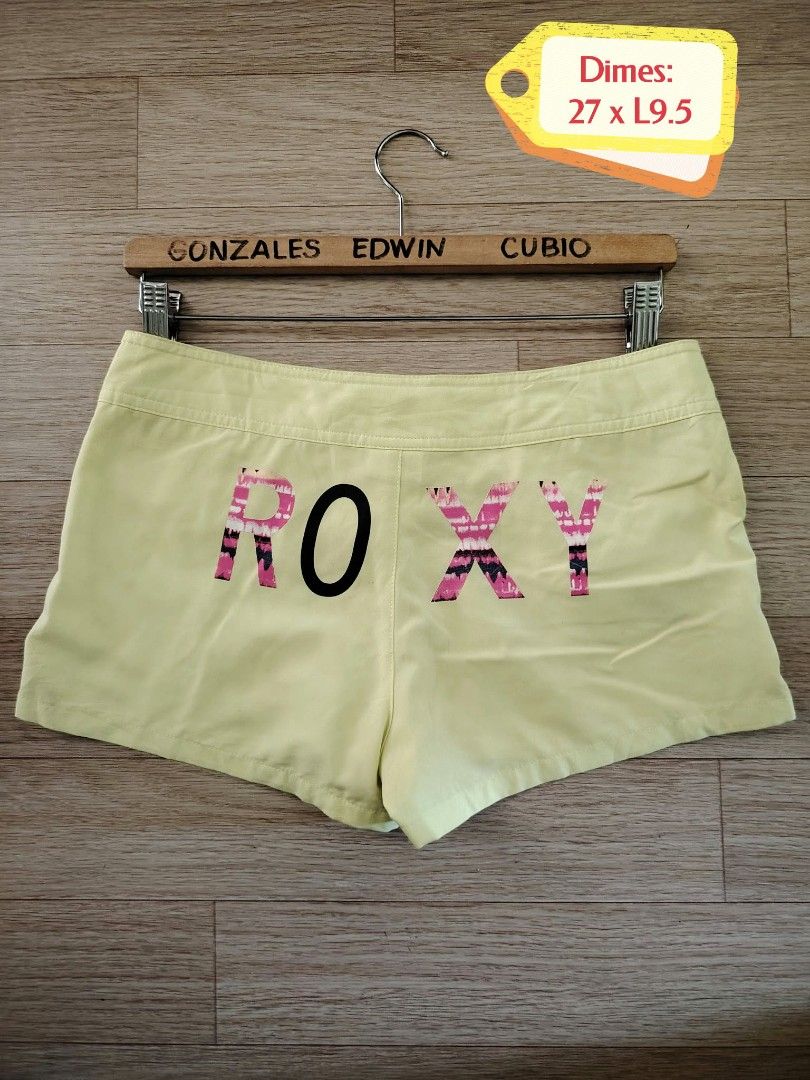 Roxy Lime Green Board Shorts Size 27 (Category: Shorts) located in Nasipit. Submitted by edwingonzales498-69377 (Listing ID 1470615573, Image 2). Description: - Brand: Roxy - Color: Lime green with pink and black tie-dye back graphic - Size: Tagged 27 (Waist: 27", Length: 9.5") - Material: 85% polyester, 15% elastane - Closure: Double snap button with heart logo hardware - Features: Two front pockets, small Roxy heart logo on lower left leg - Ori