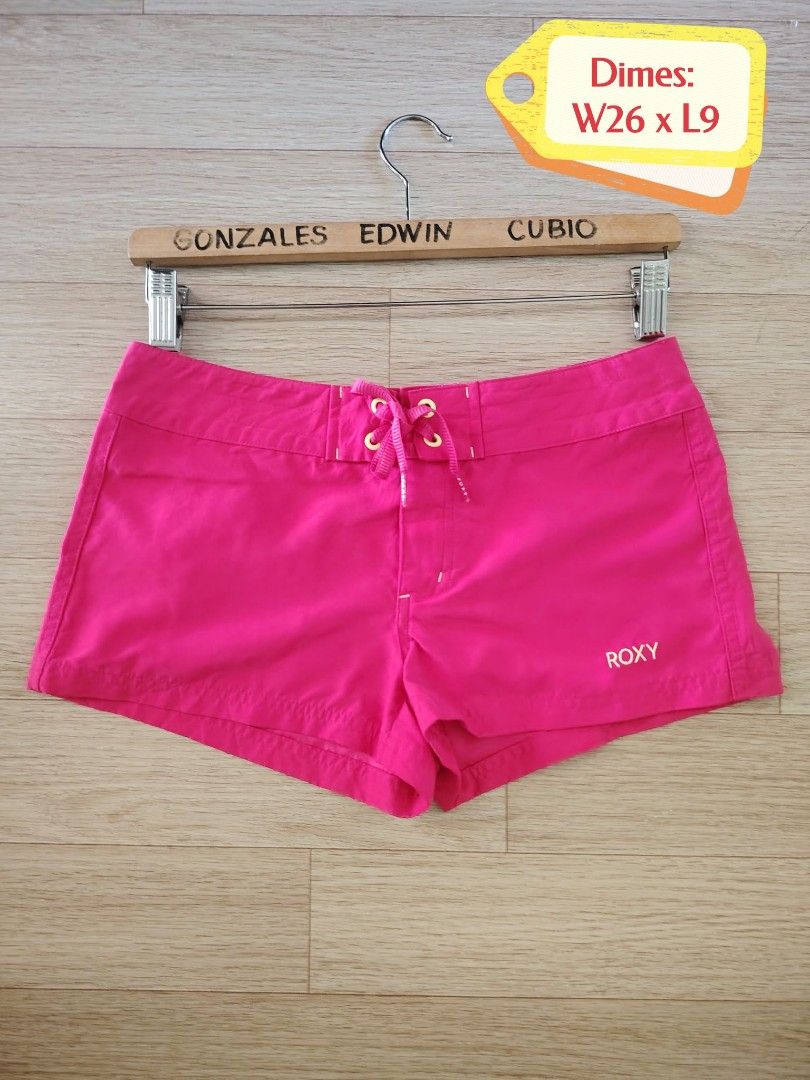 Roxy Pink Board Shorts Size 26 (Category: Bikinis & Swimsuits) located in Nasipit. Submitted by edwingonzales498-69377 (Listing ID 1470615574, Image 2). Description: - Brand: Roxy - Color: Bright pink - Size: 26 (68cm waist) - Features: Lace-up drawstring waist, back pocket with original wax comb included inside - Condition: Vibrant color, perfect for surfing and beach days - Note: Exact measurements are shown in the photos.