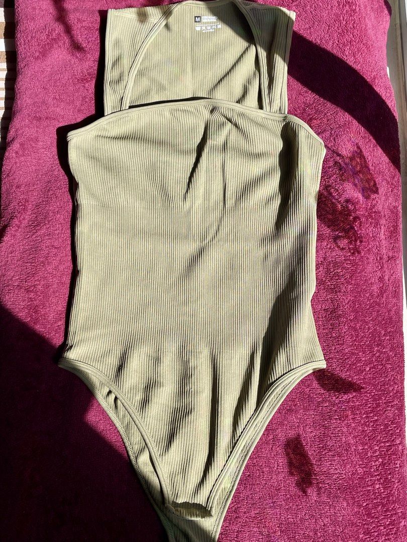 Sage green ribbed halter bodysuit size M (Category: Sleeveless) located in Manila. Submitted by nicache (Listing ID 1470609370, Image 2). Description: - Color: Sage green - Style: Halter neck with straight front neckline - Material: 90% polyamide, 10% elastane - Size: M (tag attached) - Fabric: Soft and stretchy ribbed knit - Condition: Clean and ready to wear.