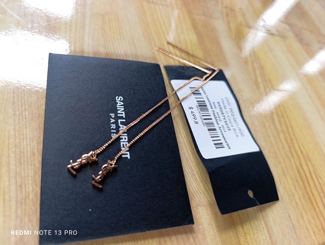Saint Laurent Opyum Threader Metal Earrings (Category: Earrings) located in Naguilian. Submitted by jhoyukay (Listing ID 1470687237, Image 1). Description: - Brand: Saint Laurent (YSL) - Style: Opyum threader earrings with chain link design and straight metal post - Finish: Pink gold with iconic YSL monogram dangling charm - Condition: Brand new, never worn, pristine condition - Inclusions: Original black brand box and tags included.