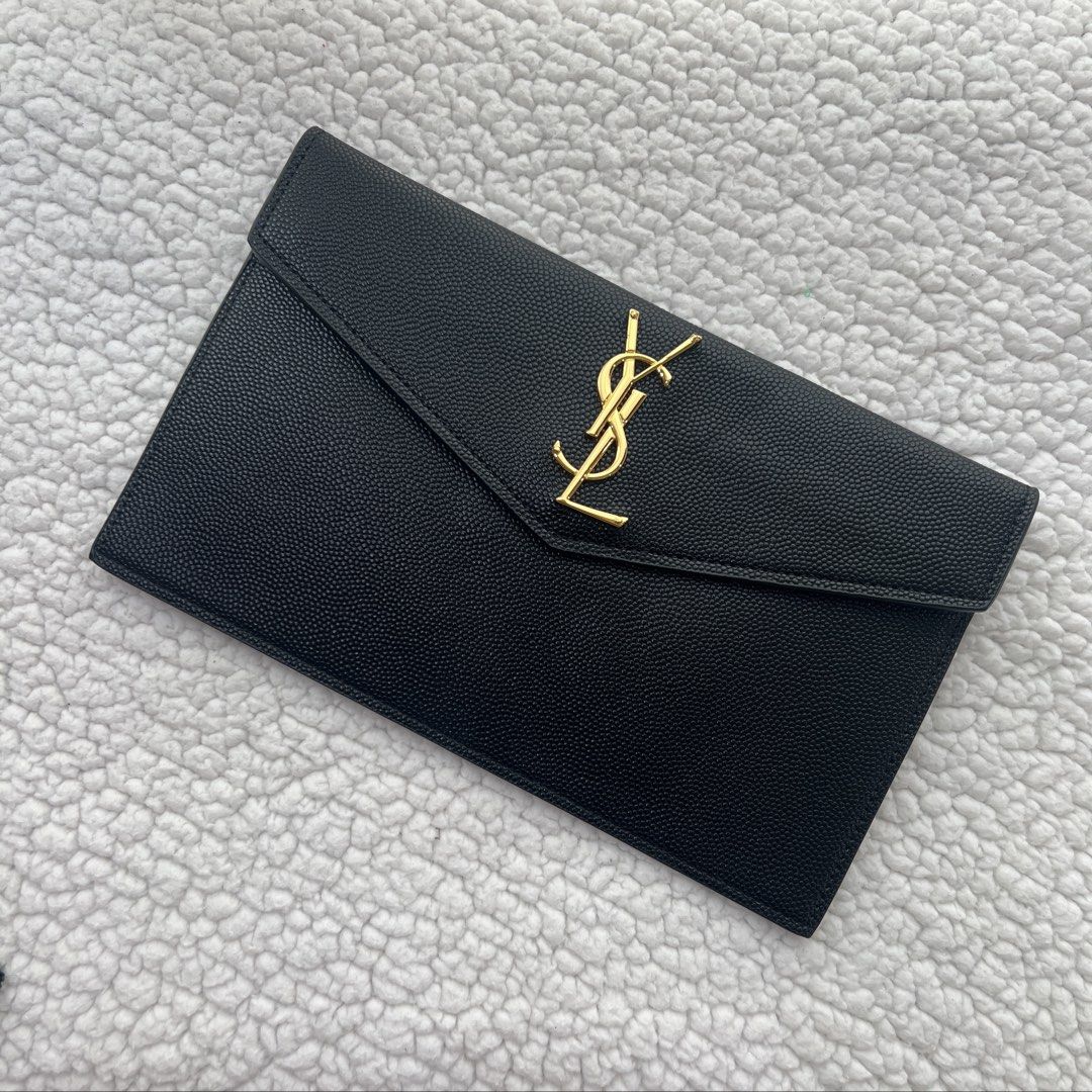 Saint Laurent YSL Clutch Bag (Category: Luxury Bags & Wallets) located in Manila. Submitted by nadascloset09 (Listing ID 1470732801, Image 1). Description: ✨ Brand‑new premium copy — perfect for special events or gifting this Christmas ✨ - Brand: Saint Laurent (YSL) - Model: Uptown Pouch / Clutch - Color: Classic Black with Gold Hardware - Material: Textured Calfskin Leather - Dimensions: Approx. 11 x 6.5 inches - Closure: Flap with magnetic snap