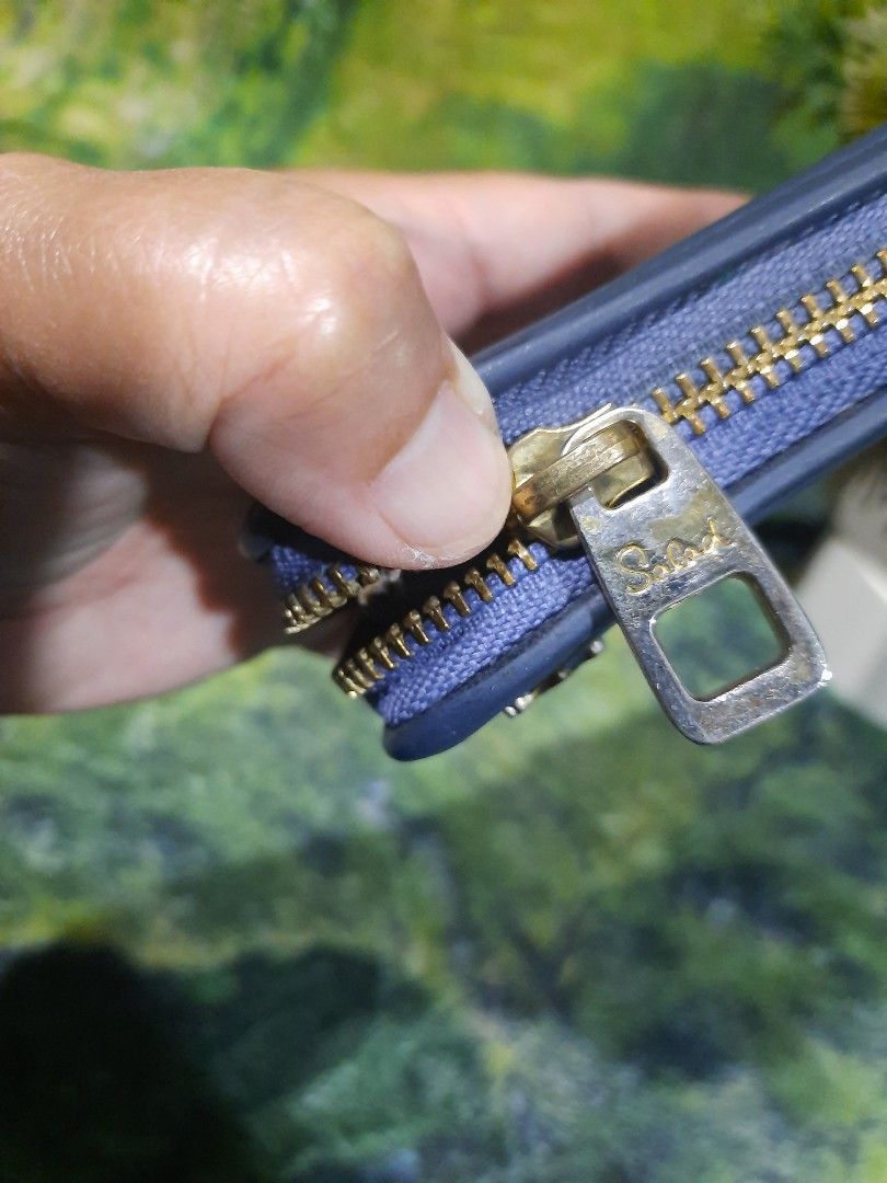 Salad Blue Long Zip Around Wallet (Category: Wallets & Card holders) located in Baguio. Submitted by klayblakeb87803 (Listing ID 1470658633, Image 3). Description: - Brand: Salad - Color: Blue - Style: Zip-around long wallet - Dimensions: Approx. 7.5" x 4" - Features: Multiple card slots, slip compartments, and a central zipped coin pocket - Details: Decorative metal corner pieces on both sides - Interior: Patterned fabric lining with brand label