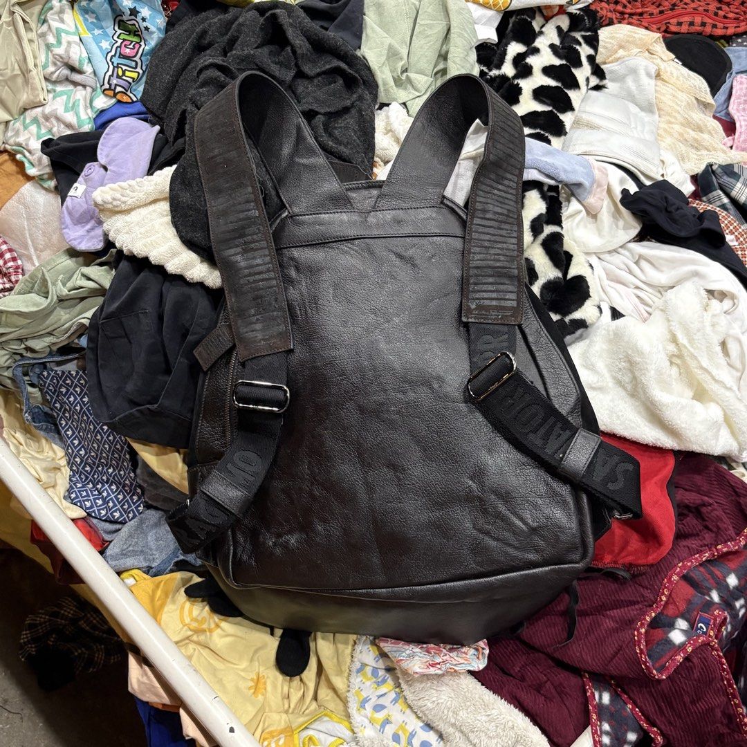 Salvatore Ferragamo Leather and Suede Backpack (Category: Backpacks) located in Zamboanga. Submitted by thriftyyali (Listing ID 1470650453, Image 2). Description: - Brand: Salvatore Ferragamo - Material: Premium black leather with suede front pocket - Closure: Double zipper with branded leather pull tabs - Straps: Adjustable with embossed logo detailing - Compartments: Spacious main compartment and exterior zip pocket - Condition & Quality: Sturd