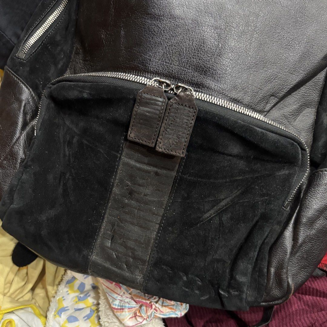 Salvatore Ferragamo Leather and Suede Backpack (Category: Backpacks) located in Zamboanga. Submitted by thriftyyali (Listing ID 1470650453, Image 3). Description: - Brand: Salvatore Ferragamo - Material: Premium black leather with suede front pocket - Closure: Double zipper with branded leather pull tabs - Straps: Adjustable with embossed logo detailing - Compartments: Spacious main compartment and exterior zip pocket - Condition & Quality: Sturd