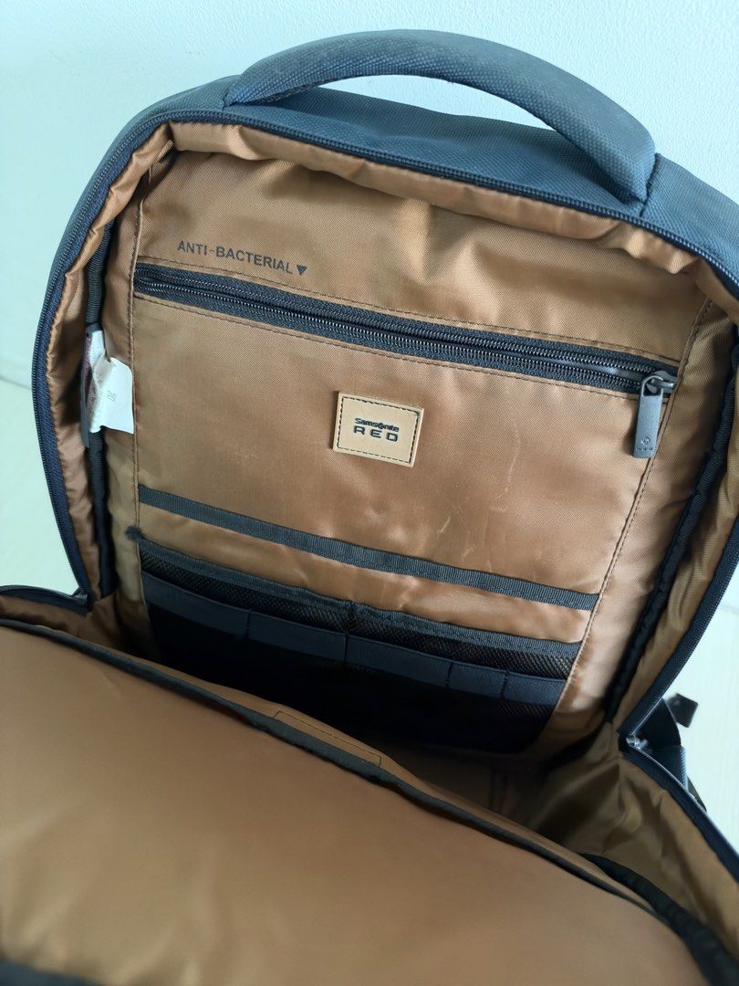Samsonite Red Anti-Bacterial Laptop Backpack (Category: Backpacks) located in Quezon City. Submitted by dlsy12 (Listing ID 1470567659, Image 3). Description: - Authentic Samsonite Red backpack in sleek dark blue - Clean brown interior featuring an anti-bacterial treatment tag - Multiple zippered compartments, mesh slip pockets, and built-in pen holders - Front zip pocket accented with a stylish dark textured panel - Comfortable padded top handle 