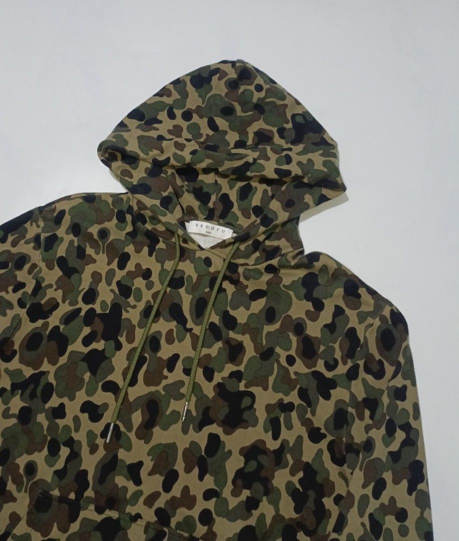 Sandro Paris Camouflage Pullover Hooded Jacket (Category: Luxury Apparel) located in Bacolod City. Submitted by luxtrend.ph (Listing ID 1470705091, Image 3). Description: Sandr0 Par¡$ Camouflage PullOver Hooded Jacket •Photos may vary due to lighting✨ •For Men •Size: Medium on tag •Measurements: 21W / 26.5L •Condition: Excellent •Issues: None •Color Rate: 9.5/10 •Complete tags •Tight Ribbings •₱rice: 2,280 shipped🏷 DM to purchase🛒🛒🛒 Courier: 