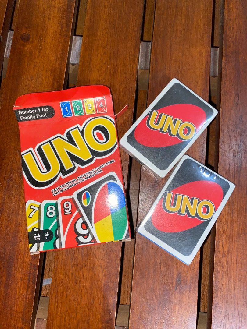 Sealed Classic UNO Card Game with Box (Category: Board Games & Puzzles) located in Pateros City. Submitted by strawberhyun (Listing ID 1470685913, Image 1). Description: - Classic UNO card game set - Includes original red cardboard storage box - Comes with 2 card decks, both still sealed in plastic wrap - Fast-paced and fun gameplay for family game nights or gatherings with friends - Perfect addition to any game collection.