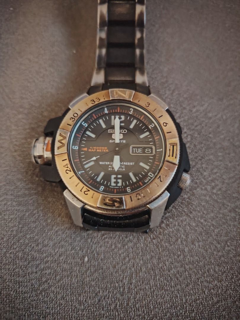 Seiko 5 Sports Map Meter Automatic Watch (Category: Men's Watches) located in Cavite. Submitted by blackrain4 (Listing ID 1470587556, Image 2). Description: - Authentic Seiko 5 Sports automatic watch - Unique map meter bezel design - Stainless steel and plastic case with black dial - Day and date display conveniently located at 3 o'clock - Reliable 23 jewels automatic movement - 200m water resistance, great for swimming and snorkeling - Black bra
