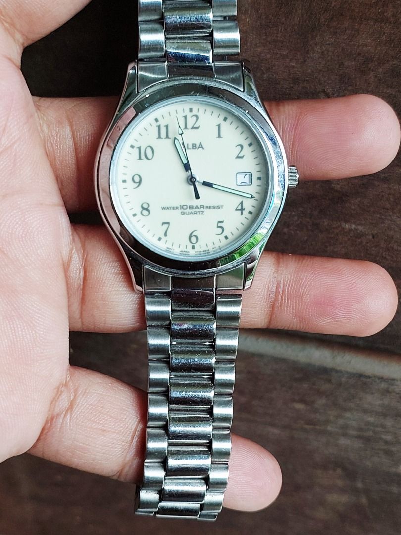 Seiko Alba Quartz Watch V732-0L80 (Category: Women's Watches) located in Batangas. Submitted by vintageanddainty (Listing ID 1470588938, Image 2). Description: - Brand: Alba - Movement: Quartz - Dial: Cream with Arabic numerals and date window at 3 o'clock - Case & Strap: Stainless steel and base metal case with stainless steel bracelet and signed clasp - Water Resistance: 10 bar - Reference: Model V732-0L80 with engraved serial number.