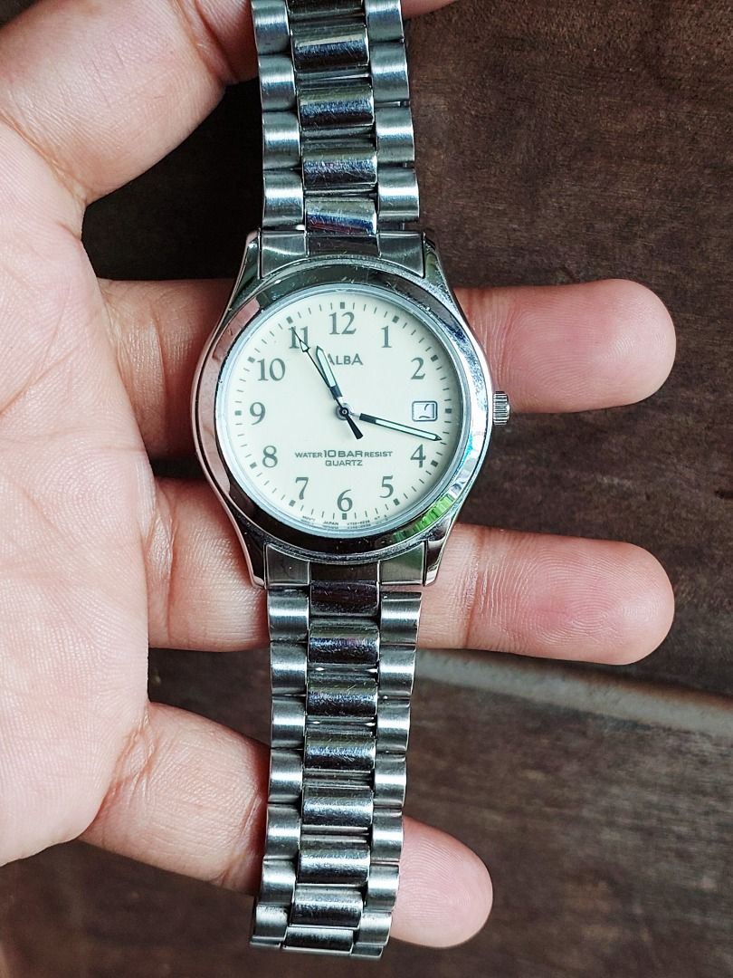 Seiko Alba Quartz Watch V732-0L80 (Category: Women's Watches) located in Batangas. Submitted by vintageanddainty (Listing ID 1470588938, Image 1). Description: - Brand: Alba - Movement: Quartz - Dial: Cream with Arabic numerals and date window at 3 o'clock - Case & Strap: Stainless steel and base metal case with stainless steel bracelet and signed clasp - Water Resistance: 10 bar - Reference: Model V732-0L80 with engraved serial number.