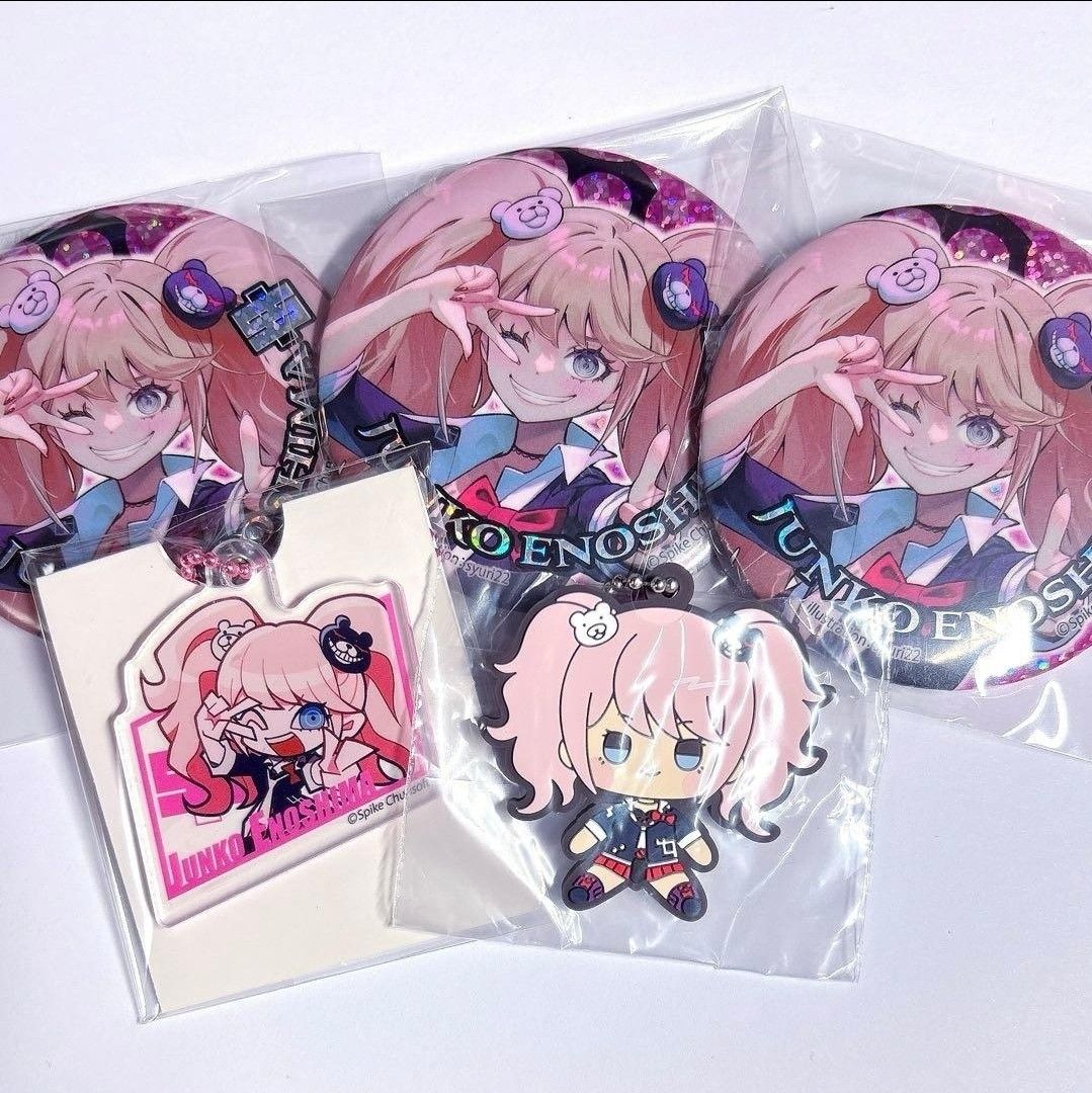 SET: Danganronpa Junko Enoshima Badges and Keychains Set (Category: Character Goods) located in Santa Cruz. Submitted by majaful1997 (Listing ID 1470734575, Image 1). Description: - Official Danganronpa Junko Enoshima collection - Includes 3 sparkly circular badges with glittering finishes - Includes 1 acrylic keychain - Includes 1 chibi rubber figure - Brand new, all items sealed in original plastic packaging - ETA: DECEMBER 2026.