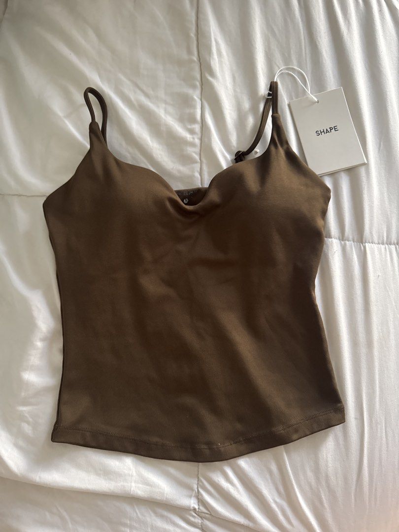 Shape Active Tone Curve Tank Top in Espresso (Category: Sleeveless) located in Pasig City. Submitted by vanillaice__ (Listing ID 1470607871, Image 2). Description: - Tone Curve tank top - worn once, condition is still perfect good as new 10/10 - Condition: Brand new with tags (BNWT) - Material: Super soft fabric with built-in support - Features: Adjustable spaghetti straps, sweetheart neckline, and small white logo on the back - Versatility: Idea