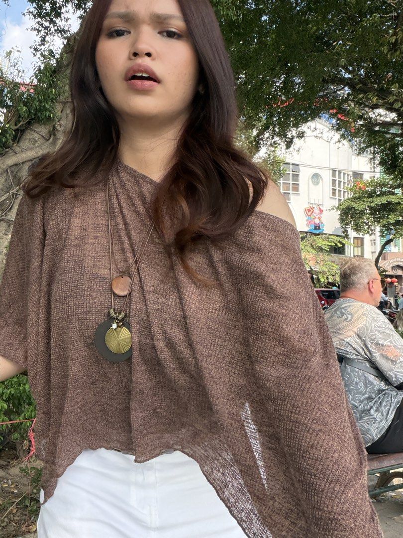 Shein Brown Poncho (Category: Others Tops) located in Manila. Submitted by wildriver.e8b64e (Listing ID 1470706838, Image 1). Description: - Color: Brown - Fit: Loose, comfortable, and breathable - Design: Stylish asymmetrical hemline with lightweight textured fabric - Condition: Worn once, excellent shape with no pulls or loose threads - Styling Tip: Perfect for layering over white pants or shorts.